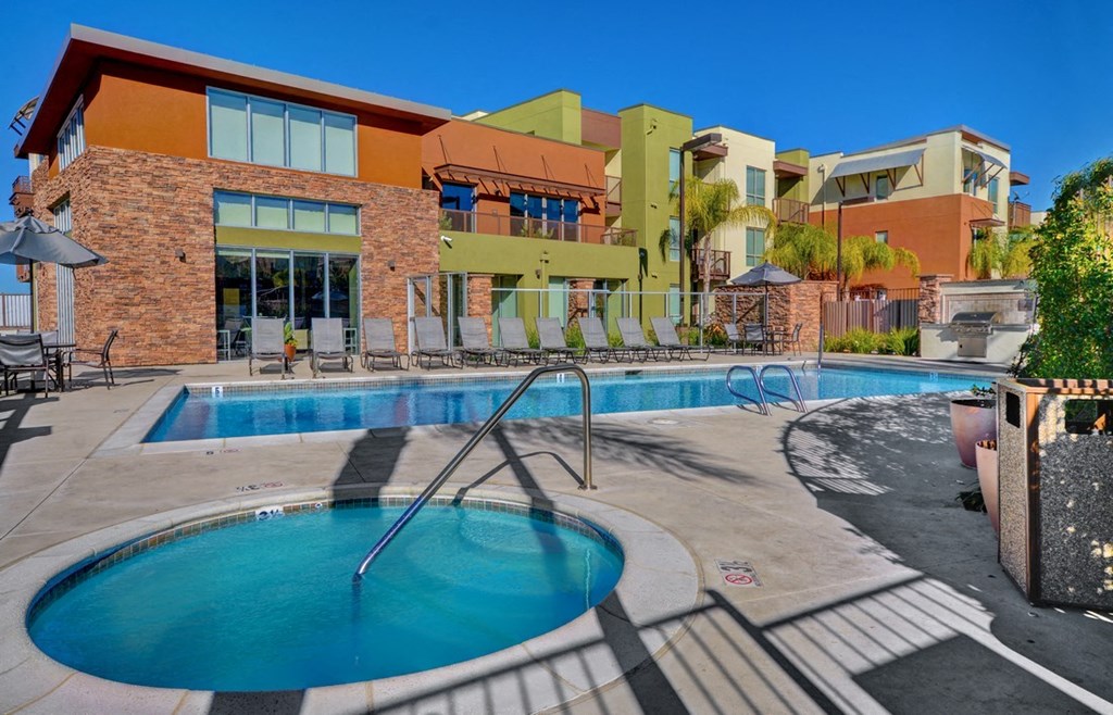 a swimming pool with a hotel in the background