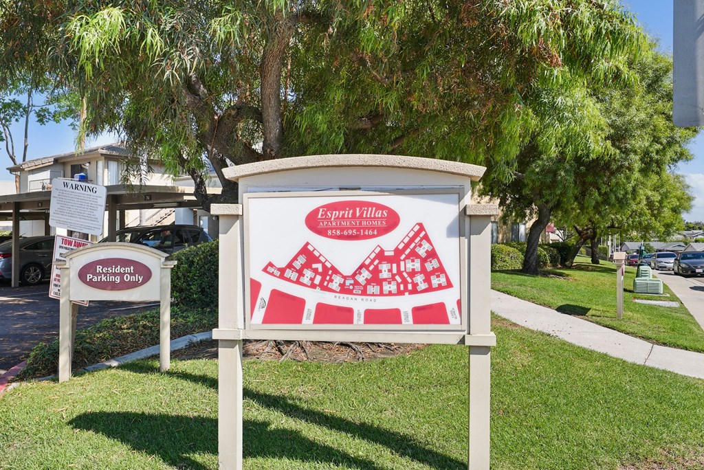 a sign in front of a building with a red and white sign