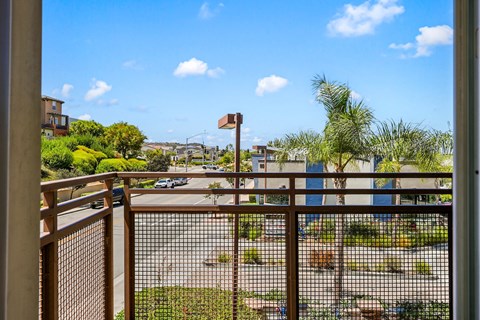 the view from the balcony of a condo overlooking a parking lot and a city