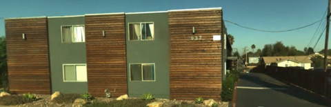 A green and brown building with the number 937 on it.