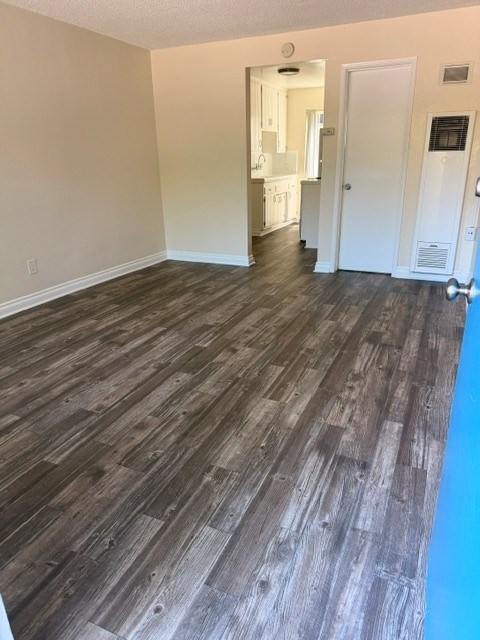 A room with a wooden floor and white walls.