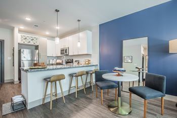 A kitchen with blue walls and a white counter.
