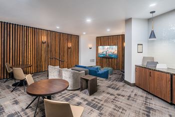 A room with a wooden wall and a carpeted floor.