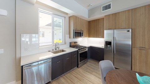 a kitchen with stainless steel appliances and a wooden table