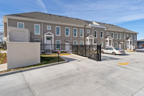 Grove Olace I large apartment building with a driveway and a parking lot
