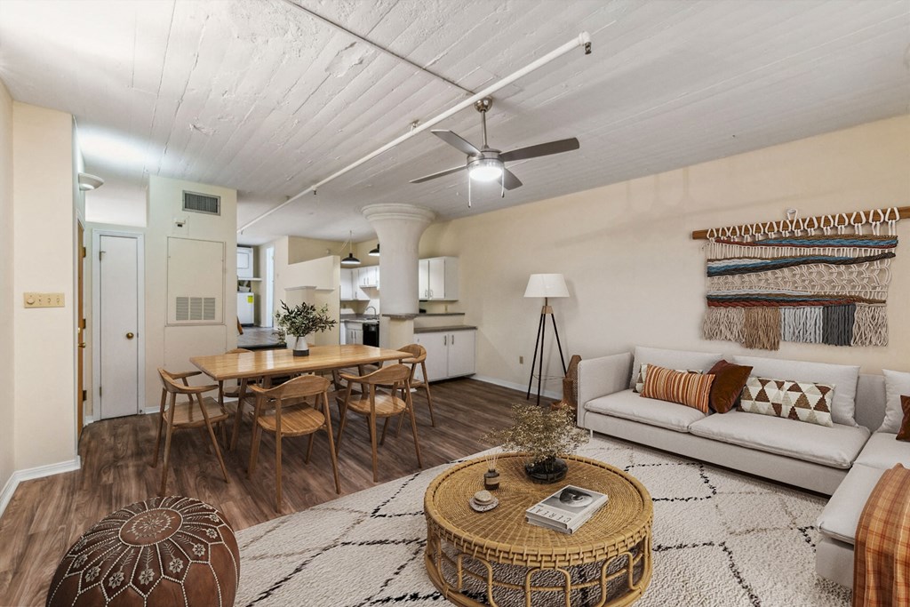 a living room with a couch and a table and a ceiling fan