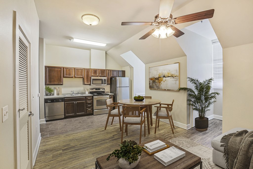 A modern kitchen with a dining table and chairs.