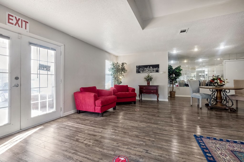 A living room with a red couch and a sign that says "EXIT".