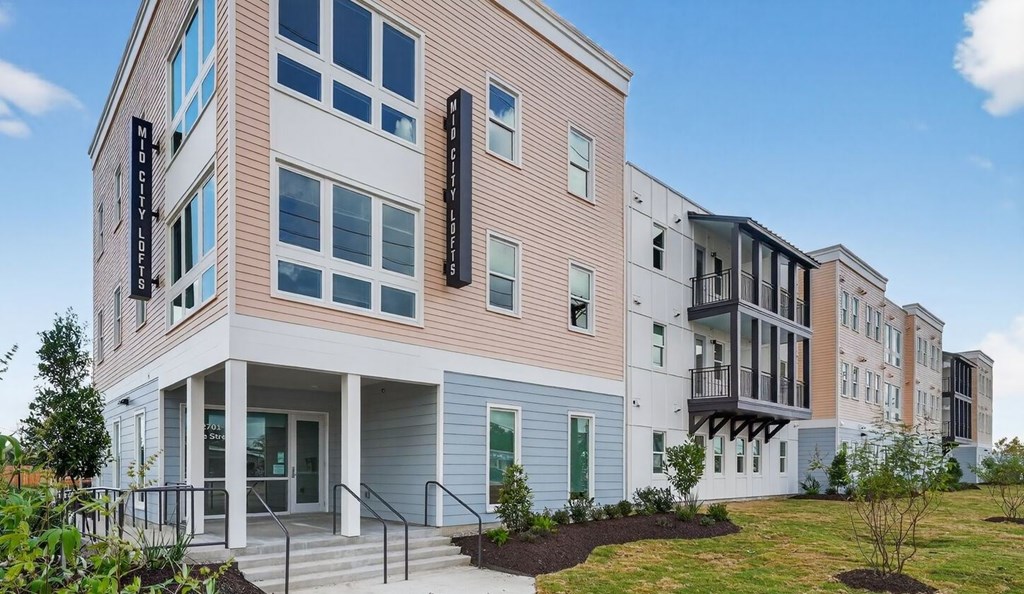 A modern building with a mix of pastel and neutral colors.
