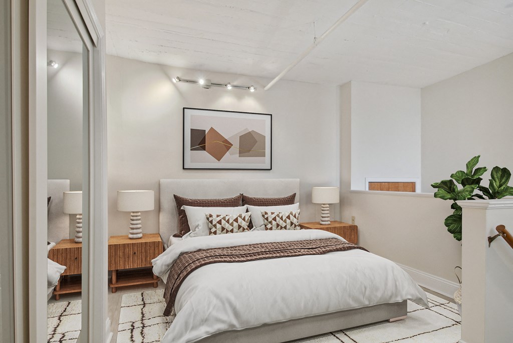 a bedroom with a bed and a painting on the wall