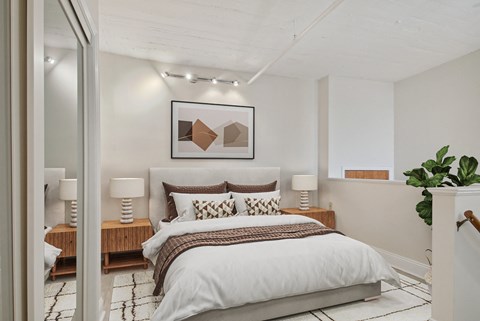 a bedroom with a bed and a painting on the wall