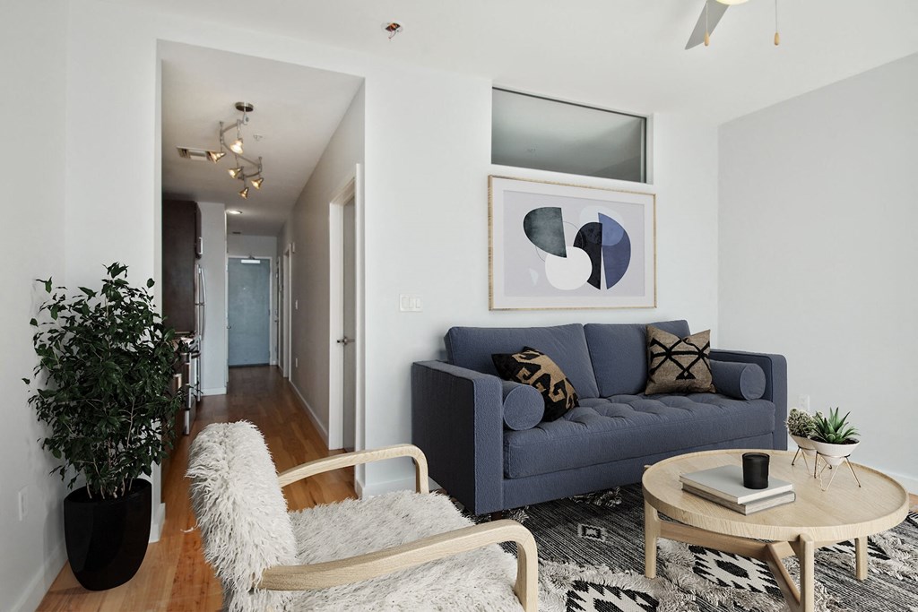 a living room with a blue couch and a coffee table