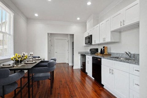a kitchen and dining room with a table and chairs