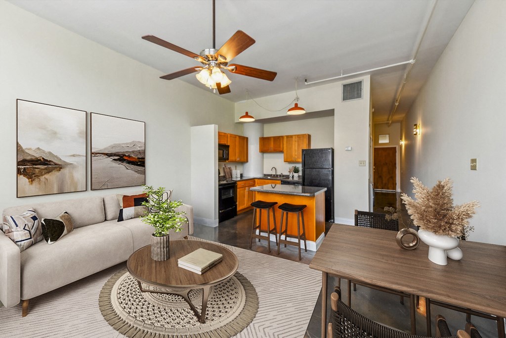 a living room with a couch and a table and a kitchen