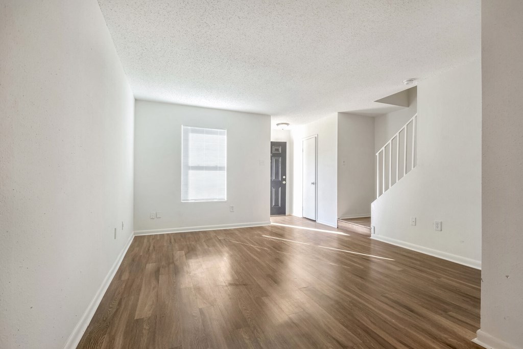 A room with wooden floors and white walls.