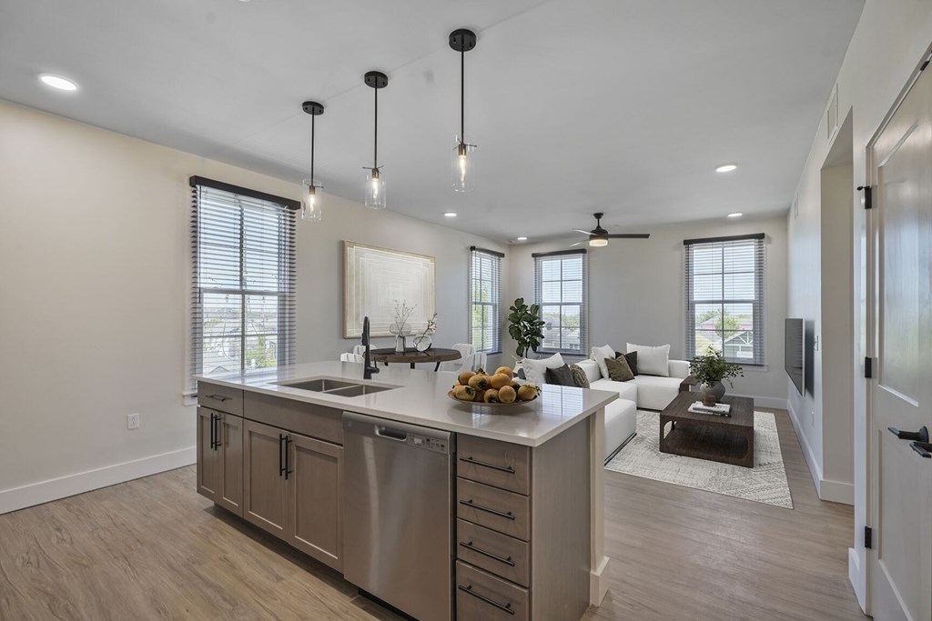 A modern kitchen with a large island and stainless steel appliances.