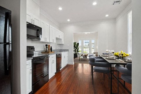 a kitchen and dining room with a table and chairs