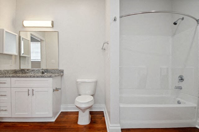 a bathroom with a toilet and a shower and a sink