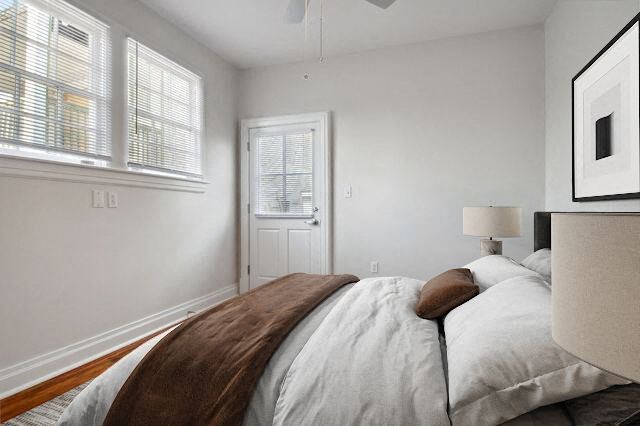 a white bedroom with a bed and a window