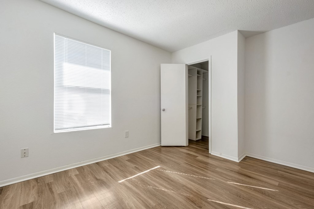 A room with a wooden floor and a white door.