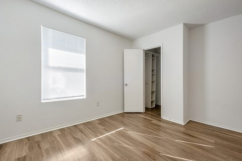 A room with a wooden floor and a white door.