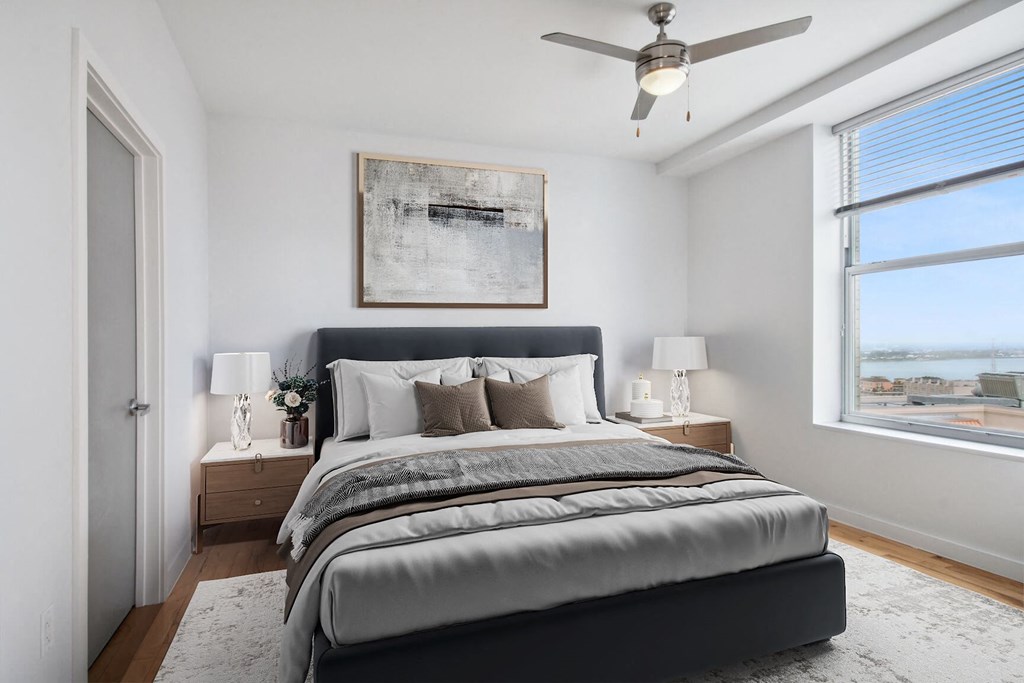 an image of a bedroom with a bed and a ceiling fan