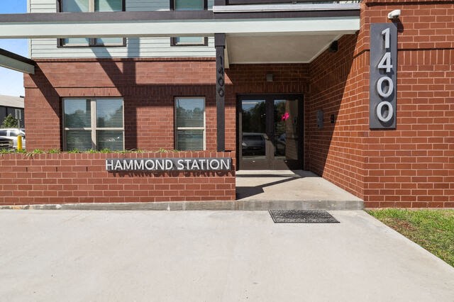 the front of a station building with a sign