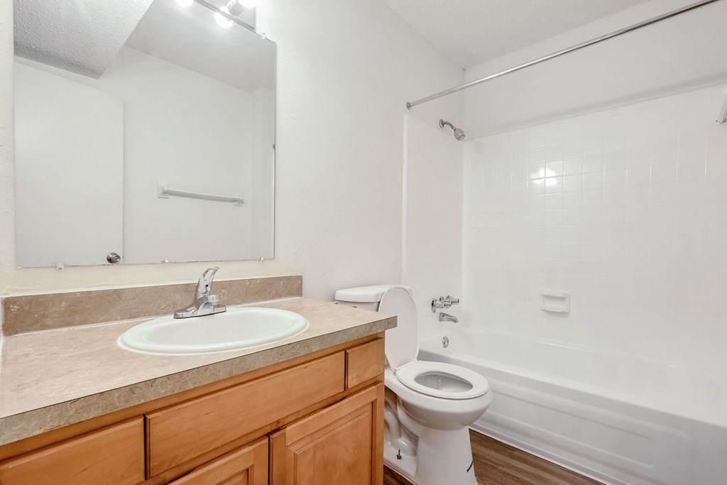 A white toilet sits next to a sink in a bathroom.