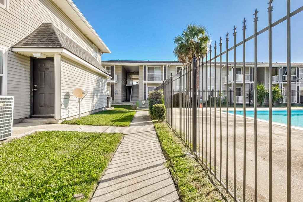 A sunny day at the apartment complex with a clear blue sky.