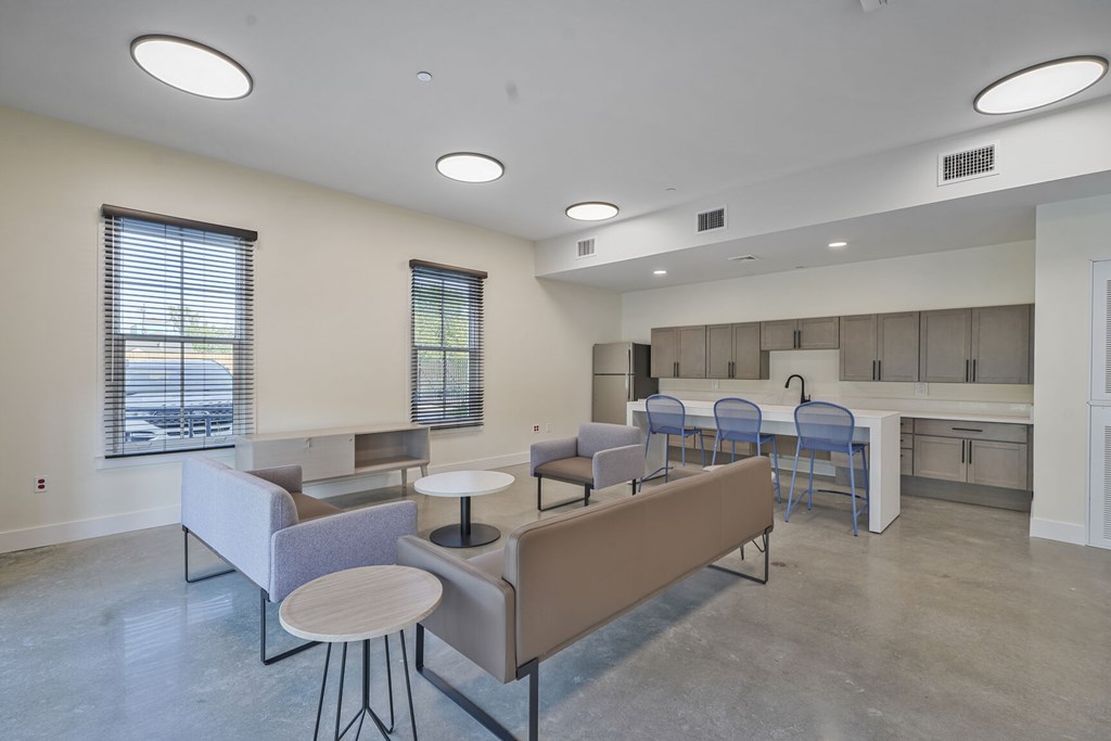 A modern living room with a grey sofa and a round table.