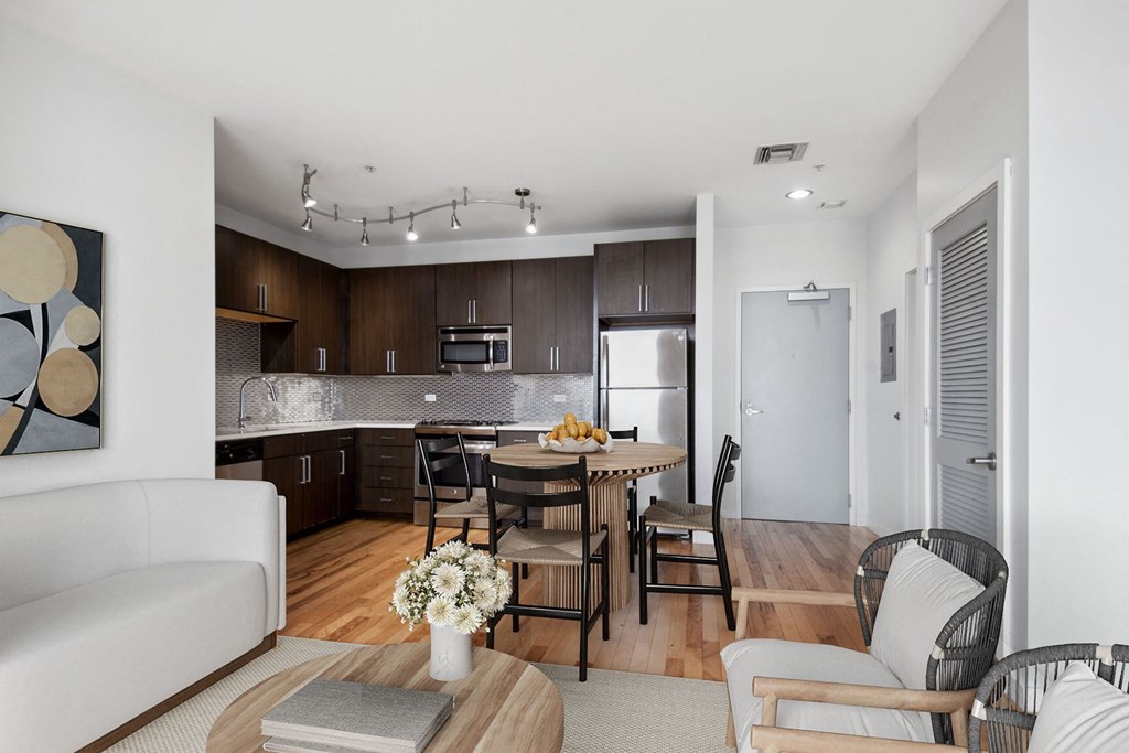 a living room and kitchen with a table and chairs
