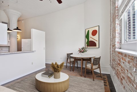 a dining room with a table and chairs and a window