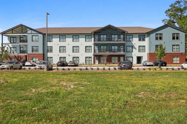 an apartment building with cars parked in front of it