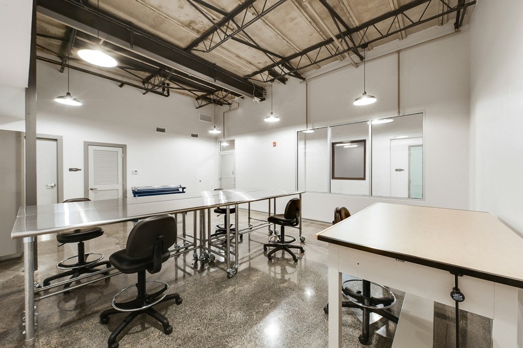 a large room with tables and chairs and a projection screen