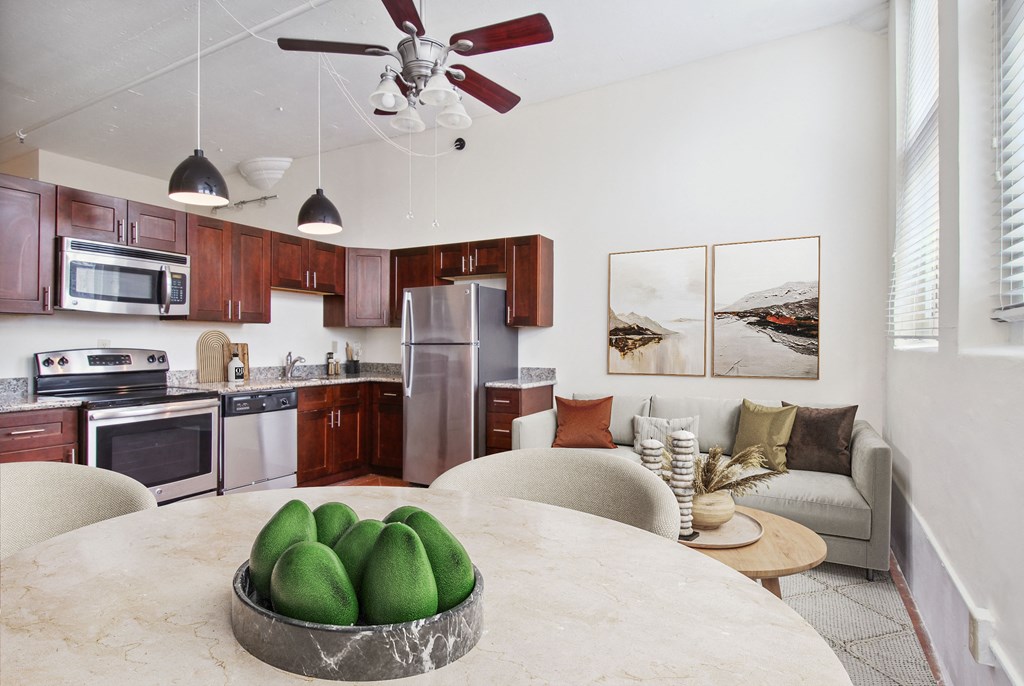 a kitchen and living room with a round table with avocado on it