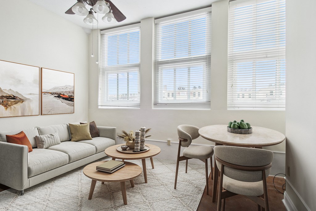 a living room with a couch and a table with chairs