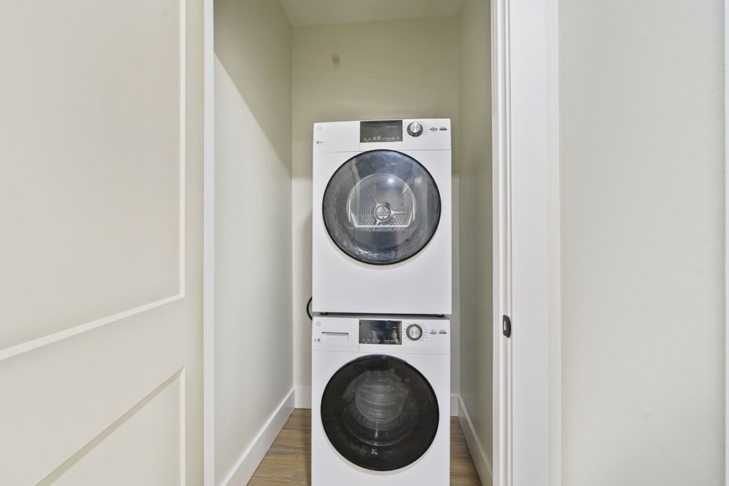 A white washing machine and dryer in a small laundry room.