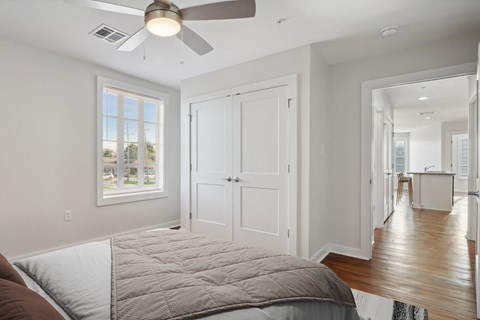 Grove Place I bedroom with a bed and a ceiling fan