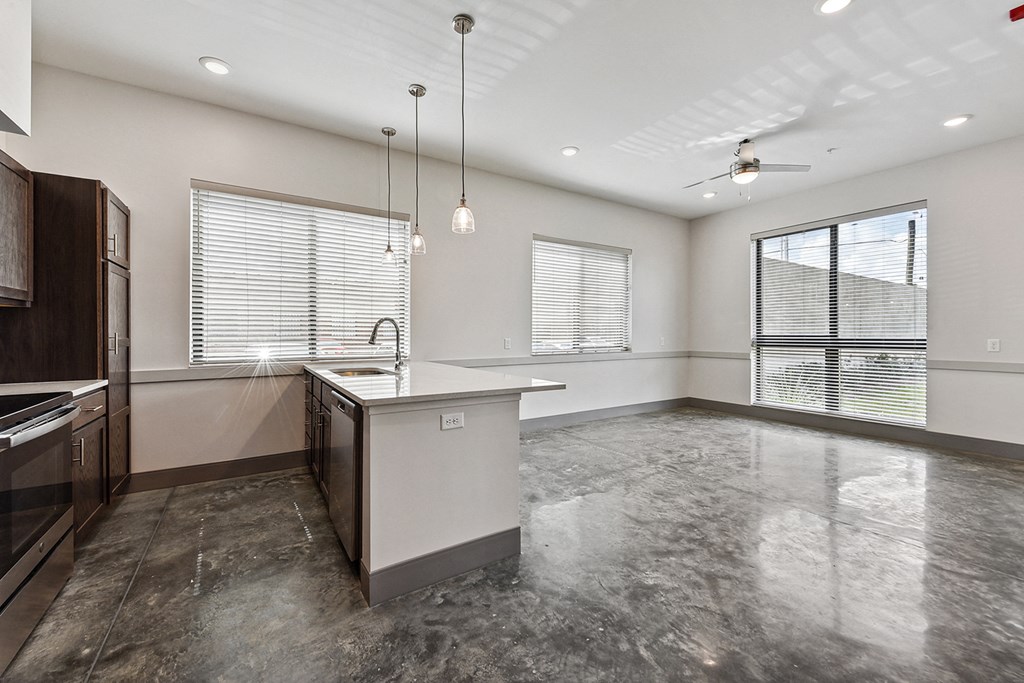 an empty kitchen with an island in the middle of it