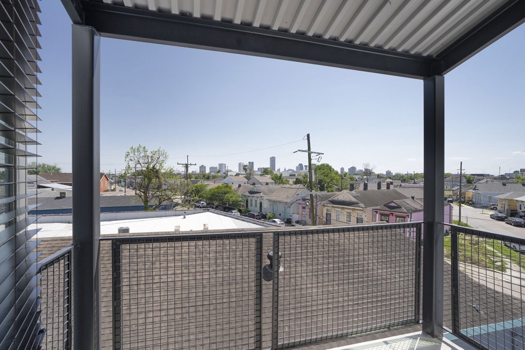 A view from a balcony looking out at a residential neighborhood.