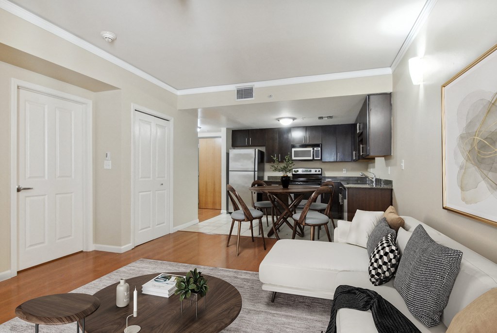 a living room and kitchen with a couch and a table