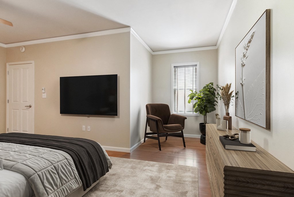 a bedroom with a bed and a tv on the wall