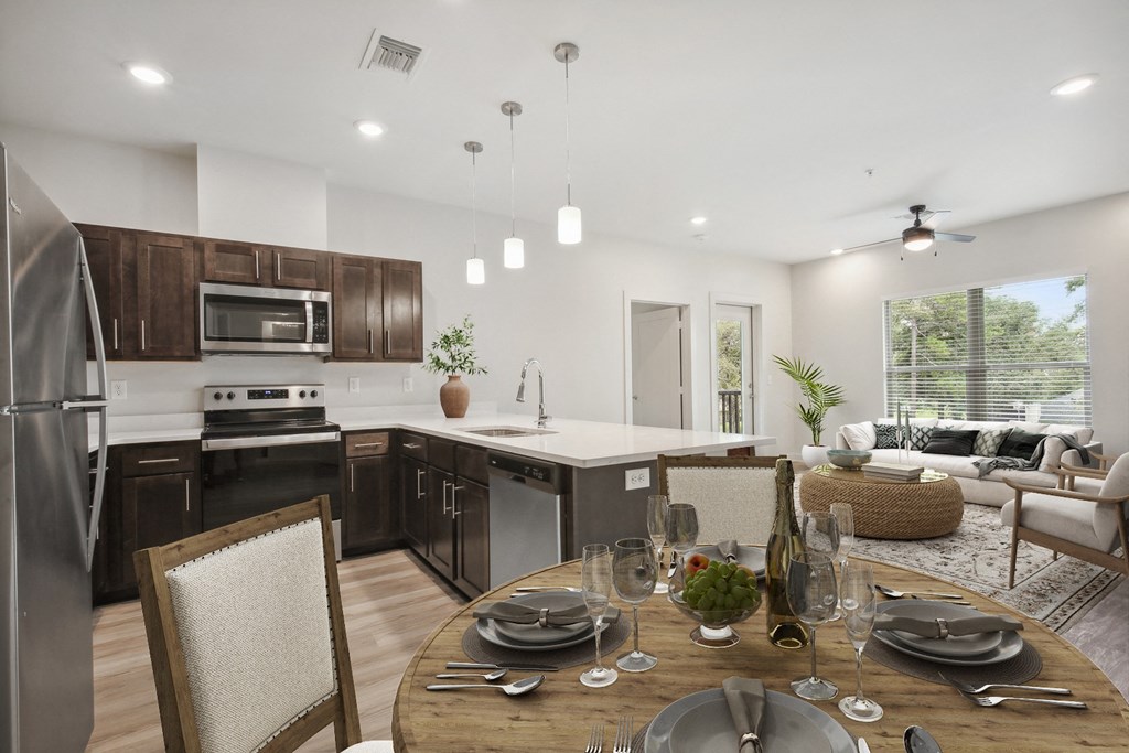 a kitchen and dining room with a table and chairs