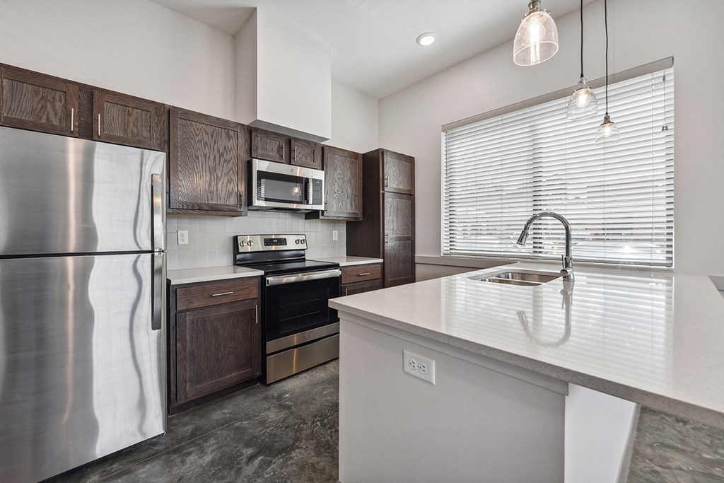 a kitchen with stainless steel appliances and a white counter top