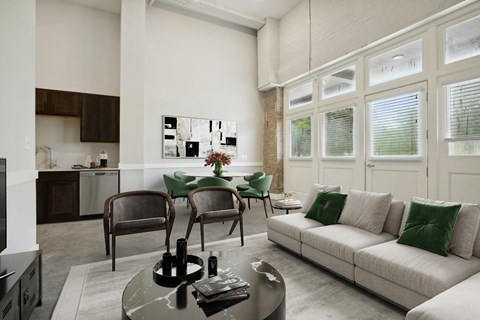 a living room with a couch and a table with chairs