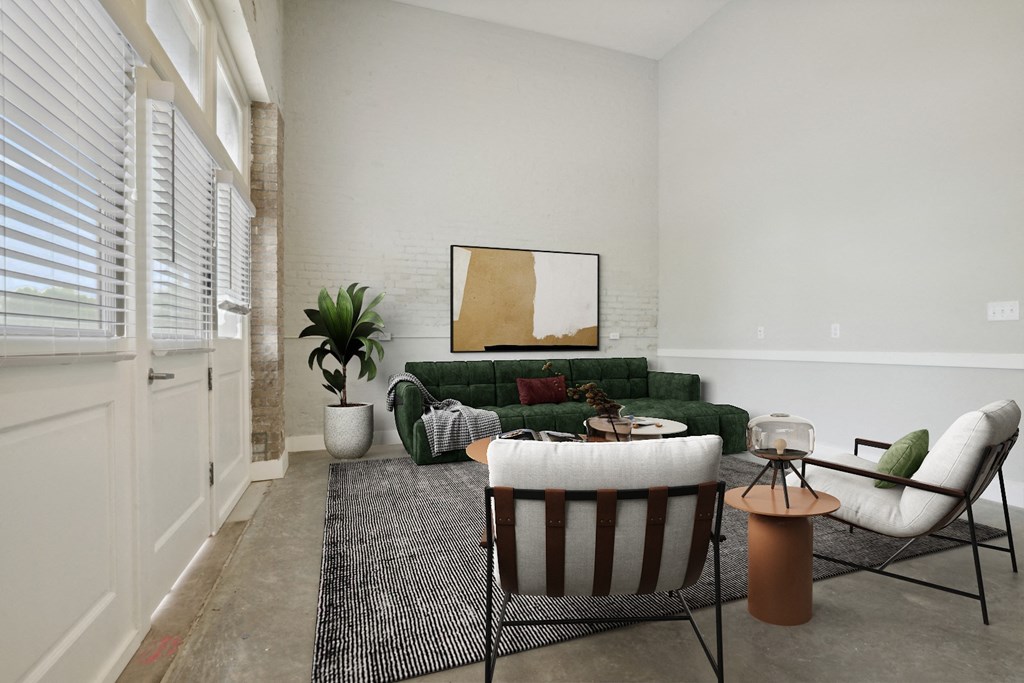 a living room with a green couch and two chairs