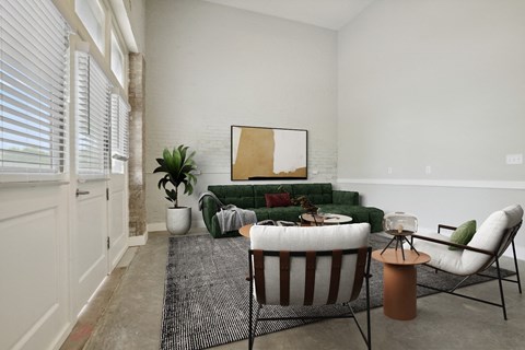 a living room with a green couch and two chairs