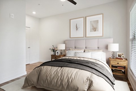 a bedroom with a large bed and a window
