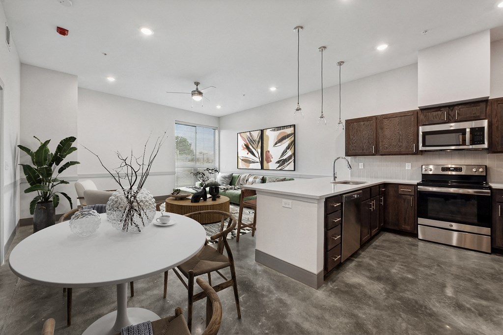 an open kitchen and dining room with a white table and chairs