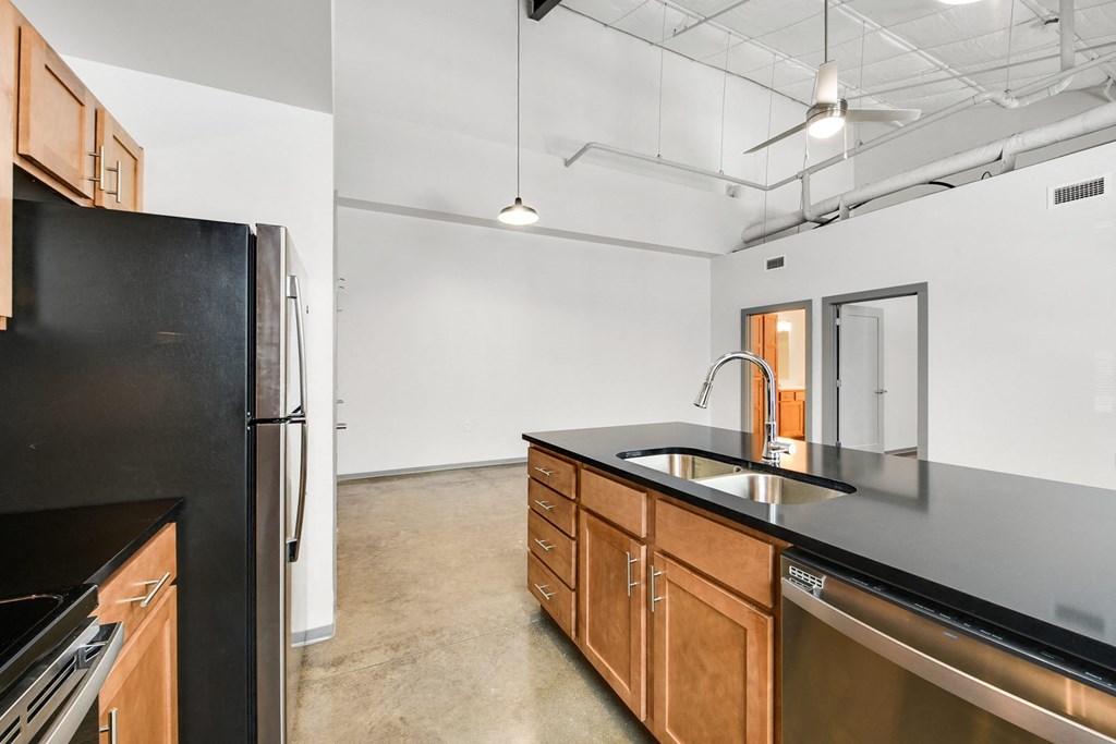 an empty kitchen with black appliances and a black refrigerator
